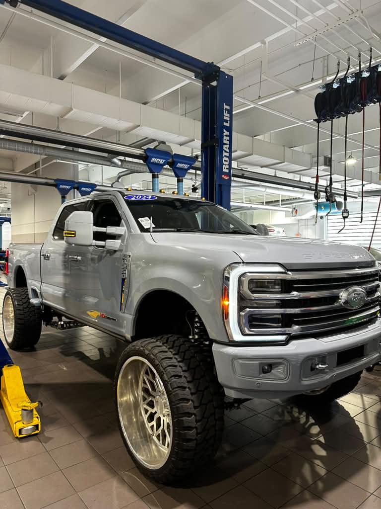 Ford Super Duty diesel truck inside a repair shop